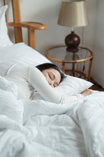 Frau schläft entspannt in einem Bett
